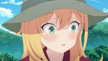 a girl with blonde hair and green eyes is wearing a green hat