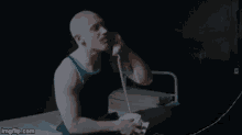 a bald man talking on a phone with the words " absolutely not " written below him