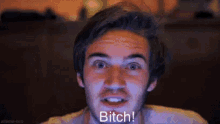 a man with a beard is making a funny face and saying `` bitch '' .