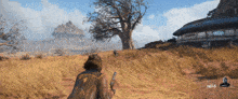 a video game screen shows a man holding a gun in a field with the number 5 on the bottom