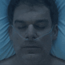 a man laying in a hospital bed with an oxygen mask on his face