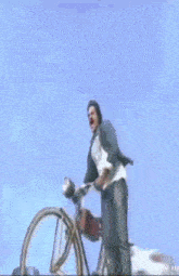 a man is standing on top of a motorcycle with a helmet on