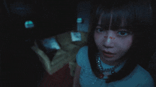a girl with a necklace around her neck has a sticker on her face that says ' i love you '