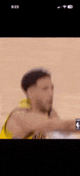 a basketball player is making a funny face while holding a basketball .