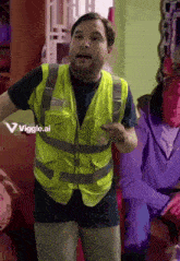 a man in a yellow vest is standing in front of a sign that says ' viggle.ai '