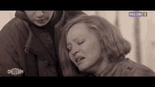 a woman is crying in front of a sign that says russia