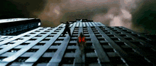 a person standing on top of a building with a red light coming out of it
