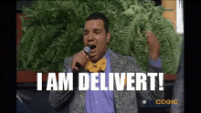 a man is singing into a microphone with the words i am delivert written below him .