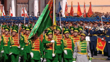 a group of soldiers marching in a parade holding flags