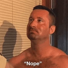 a shirtless man is standing in front of a window and says " nope "