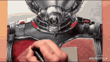 a person is drawing a picture of an ant man