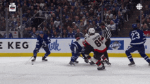 a hockey game is being played in front of a crowd and a sign that says e keg
