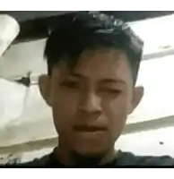 a man is making a funny face while looking at the camera .