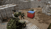 a soldier in a video game is looking at a red container with a blue lid