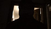 a man standing in a dark room with the words 1 hokka written on the bottom