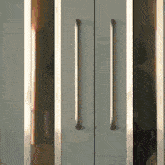 a close up of a door with a reflection of a person behind it