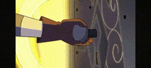 a hand is holding a bottle of perfume in front of a wall .