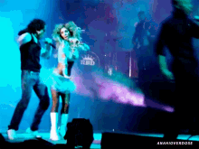 a woman singing in front of a drum with the word rbd on it