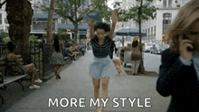 a woman is running down a city street with the words `` more my style '' written on the bottom .