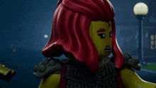 a close up of a lego figure with red hair and the word ninjago on her chest