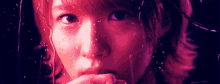 a close up of a woman 's face with a purple background