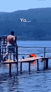 a man is standing on a dock overlooking a body of water with the words yo written on the bottom