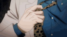 a close up of a person 's hand holding a tie