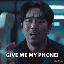 a man is holding a cell phone and asking for a phone call from netflix