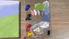 a person is painting a picture with a palette that says made in animatica on the bottom