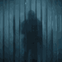 a man in armor is standing in a dark room