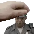 a police officer is being patted on the head by a person .