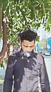 a man in a black shirt is smoking an electronic cigarette