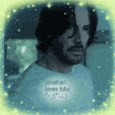 a man with a beard is wearing a t-shirt that says jonathan loves toby