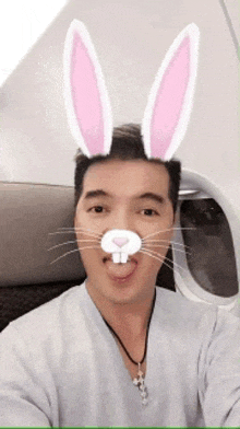 a man is wearing bunny ears on his face