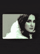 a woman in a fur coat is sitting in a chair with her legs crossed