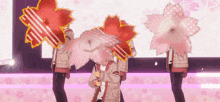 a group of people holding umbrellas that look like cherry blossoms .