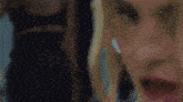 a close up of a woman 's face with her eyes closed