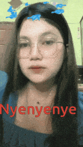 a woman wearing glasses and a headband with dolphins on it has the word nyenye written on her face