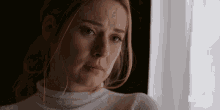 a woman is looking out a window with a netflix logo in the corner