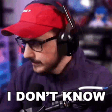 a man wearing a red hat and headphones says i don 't know .