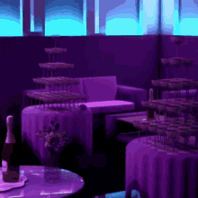 a bottle of champagne sits on a table in front of a purple couch