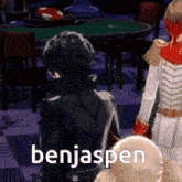 a video game character is standing in front of a table with the name benjaspen on it