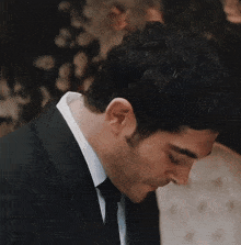 a man kisses a woman 's hand in a wedding dress