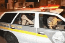 a white and yellow police car with the word policia on the side