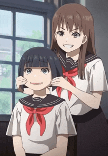 two anime girls are standing next to each other and one of them is putting a red scarf around another girl 's neck