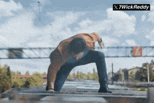 a man is crawling on a ladder with a 7wick reddy logo in the background