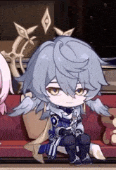 a boy with wings is sitting on a couch in a room .