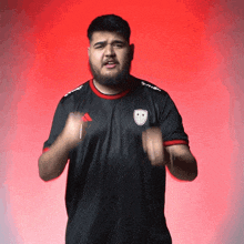 a man with a beard wearing a black shirt with the word seven on it