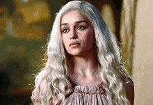 a woman with long blonde hair is wearing a red dress