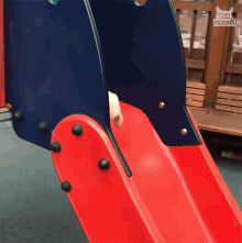 a cat is going down a slide at a playground that says collective on the bottom